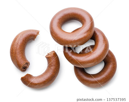 Cocoa dried bagels and two halves close up on a white. Top view Cocoa dried bagels and two halves close up on a white. Top view 137537395