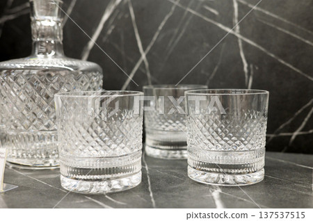 Elegant crystal decanter and glass set on marble surface Elegant crystal decanter and glass set on marble surface 137537515