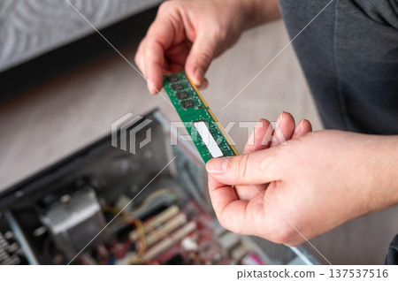 Person installing ram in desktop computer for hardware upgrade 137537516