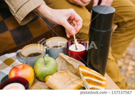 Cozy autumn picnic with candles, coffee, and fresh apples Cozy autumn picnic with candles, coffee, and fresh apples 137537567