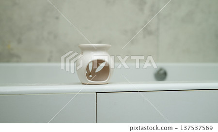 Ceramic oil burner on minimalist bathroom counter 137537569