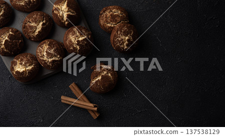 Cinnamon crinkle cookies on a black background with copy space, flat lay Cinnamon crinkle cookies on a black background with copy space, flat lay 137538129