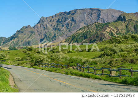 Driving scenery through the majestic mountain ranges and grasslands of Aso Driving scenery through the majestic mountain ranges and grasslands of Aso 137538457