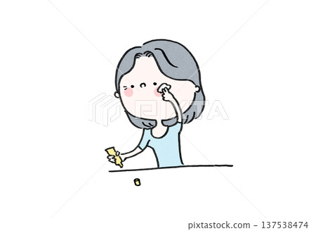 A woman gently applying eye cream to fine lines and dark circles around the eyes (skin care) 137538474