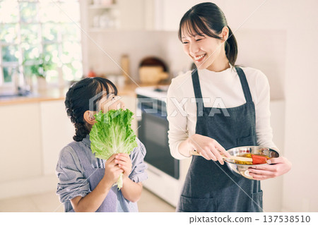 Parents who cook in the kitchen Parents who cook in the kitchen 137538510