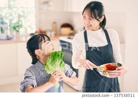 Parents who cook in the kitchen Parents who cook in the kitchen 137538511