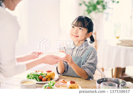 Girl helping with meals Girl helping with meals 137538657