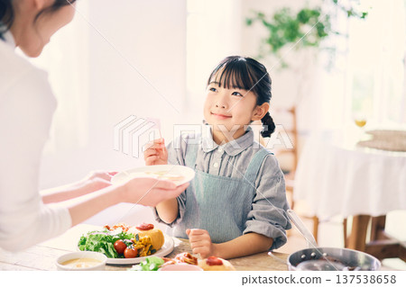 Girl helping with meals Girl helping with meals 137538658