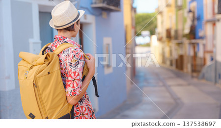 Woman strolls through colorful streets of Spanish coastal town 137538697