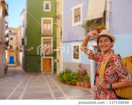 Woman strolls through colorful streets of Spanish coastal town 137538698