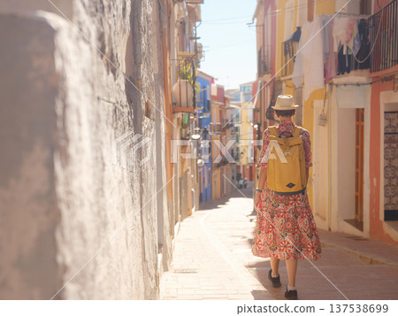 Woman strolls through colorful streets of Spanish coastal town 137538699