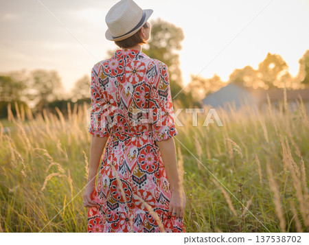 boho chic woman in a floral dress in European countryside boho chic woman in a floral dress in European countryside 137538702