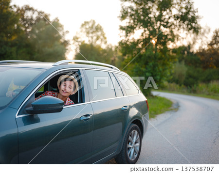 Traveler woman drives car through scenic countryside of Croatia Traveler woman drives car through scenic countryside of Croatia 137538707
