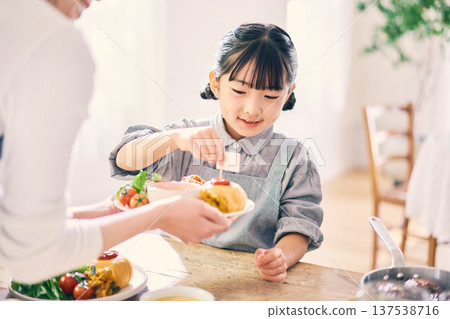 Girl helping with meals Girl helping with meals 137538716