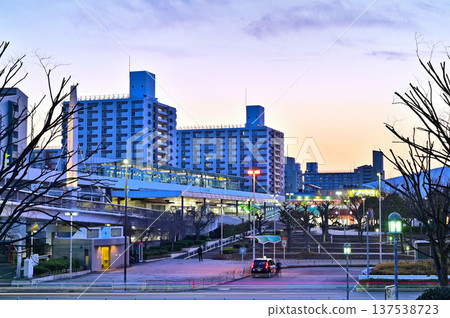 A monorail running through an apartment complex at dusk A monorail running through an apartment complex at dusk 137538723