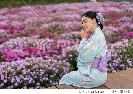 woman in yukata (kimono dress) with flower blooming in garden 137538758