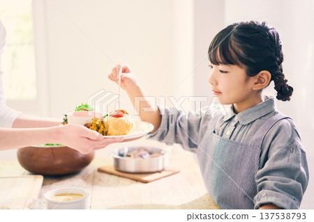 Girl helping with meal preparation 137538793