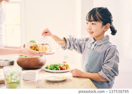 Girl helping with meal preparation 137538795