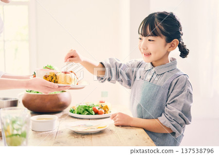 Girl helping with meal preparation 137538796