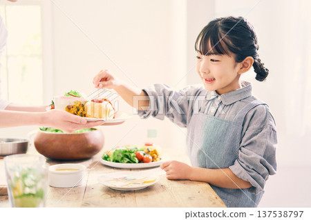 Girl helping with meal preparation 137538797