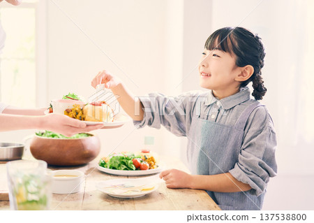 Girl helping with meal preparation Girl helping with meal preparation 137538800