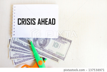 A notebook with the text Crisis Ahead with dollars . Business concept 137538971