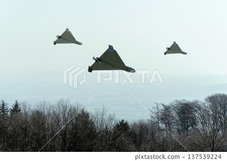 Military unmanned kamikaze drones perform attack and patrol in the sky. Military unmanned kamikaze drones perform attack and patrol in the sky. 137539224