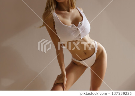 Sexy busty blonde woman with large breasts in white lingerie, beauty body care and plastic surgery concept 137539225