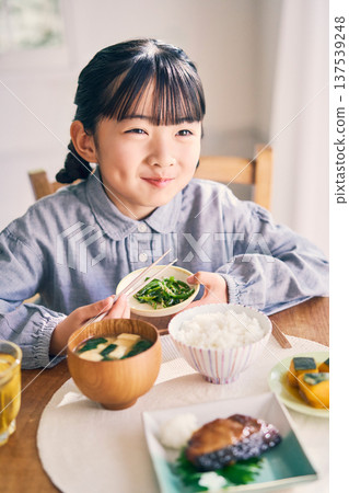 Girl eating breakfast at home Girl eating breakfast at home 137539248