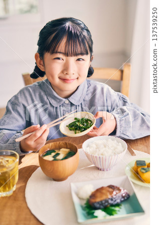 Girl eating breakfast at home Girl eating breakfast at home 137539250