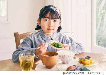 Girl eating breakfast at home Girl eating breakfast at home 137539313