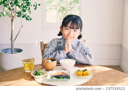 Girl eating breakfast at home Girl eating breakfast at home 137539323