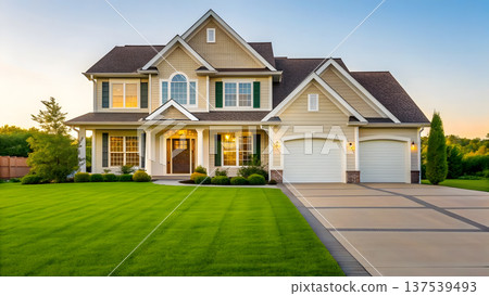 Modern suburban house with manicured lawn and double garage in evening light 137539493