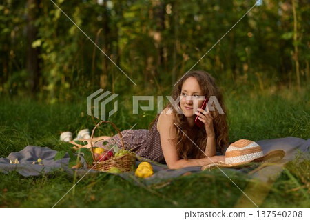 Artist juggling sketching and phone call at picnic 137540208