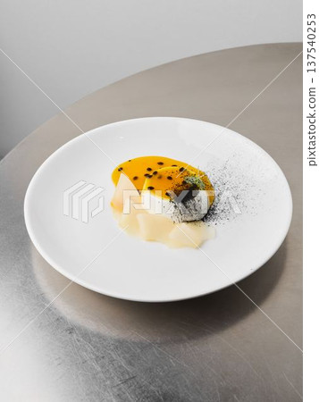 Silky custard served with lively passionfruit glaze and delicate garnish Silky custard served with lively passionfruit glaze and delicate garnish 137540253