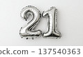 Silver foil balloons shaped as number 21 on white background 137540363