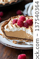 Delicious peanut butter pie with whipped cream and fresh raspberries 137540364