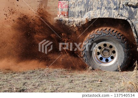 off-road racing on dusty terrain off-road racing on dusty terrain 137540534