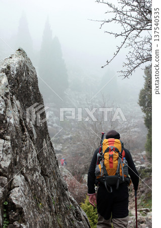 mountaineer walking on an ancient road mountaineer walking on an ancient road 137540535