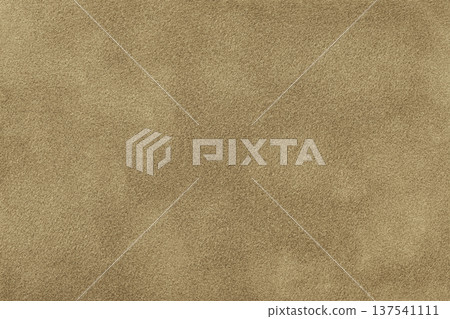Light brown suede fabric background with matte nap velvet texture. Warm beige tones and soft felt textile surface, macro 137541111