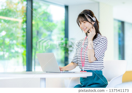 Young woman working in a call center Young woman working in a call center 137541173