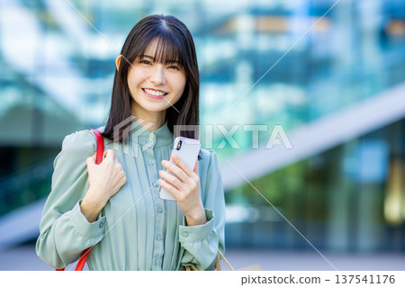 Business woman with a smartphone Business woman with a smartphone 137541176