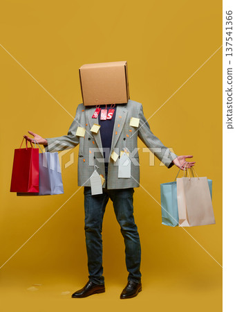 Man with box on head holding shopping bags retail sale 137541366