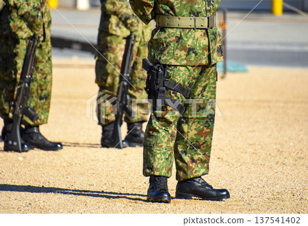Ground Self-Defense Force personnel carrying a pistol Ground Self-Defense Force personnel carrying a pistol 137541402