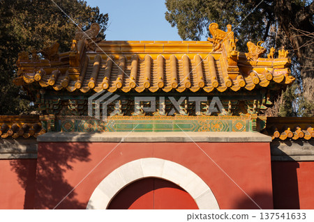 Traditional chinese temple gate with yellow tiled roof 137541633