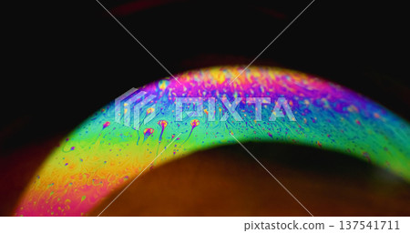 Rainbow curve. Defocused gasoline fluid. Soap fluorescent mix glow arch on black background. Abstract color neon gradient ink copy space. 137541711