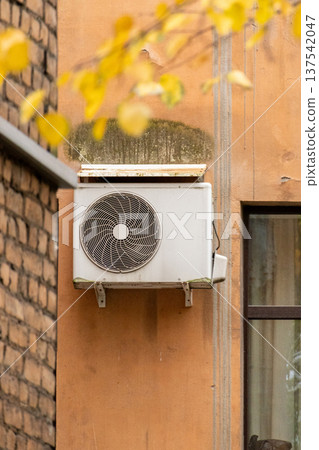 air conditioning on facade of building, air cooling in hot weather. air conditioning on facade of building, air cooling in hot weather. 137542047