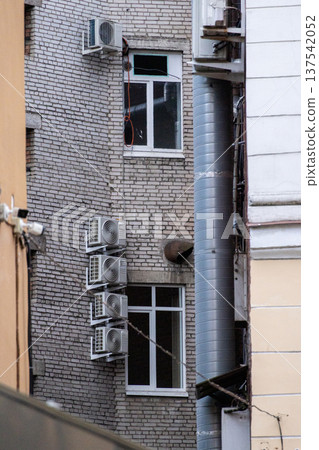 air conditioning on facade of building, air cooling in hot weather.  137542052