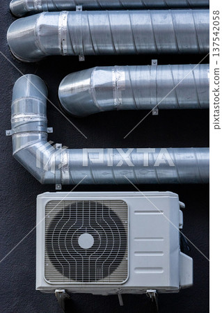 air conditioning on facade of building, air cooling in hot weather. air conditioning on facade of building, air cooling in hot weather. 137542058