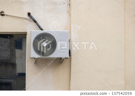 air conditioning on facade of building, air cooling in hot weather. air conditioning on facade of building, air cooling in hot weather. 137542059